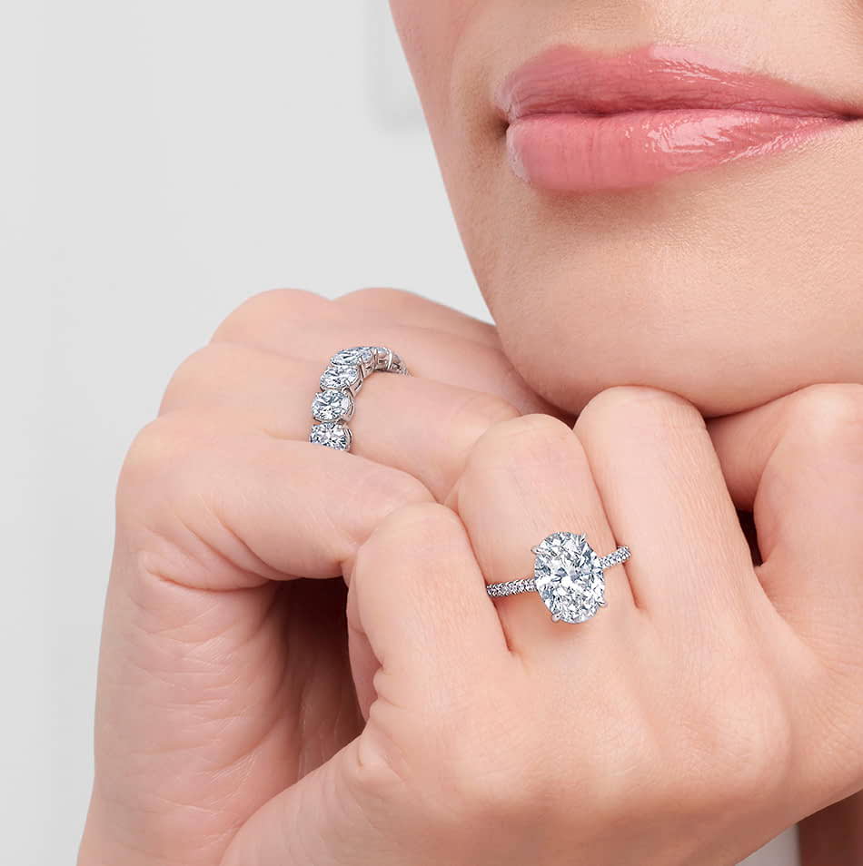 Hand model wearing a Kwiat oval diamond engagement ring. 