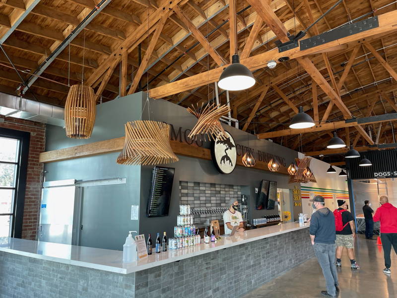 wide angle view of our SteelCraft locatio in long beach, people can be seen on stools enjoying food and beer. 