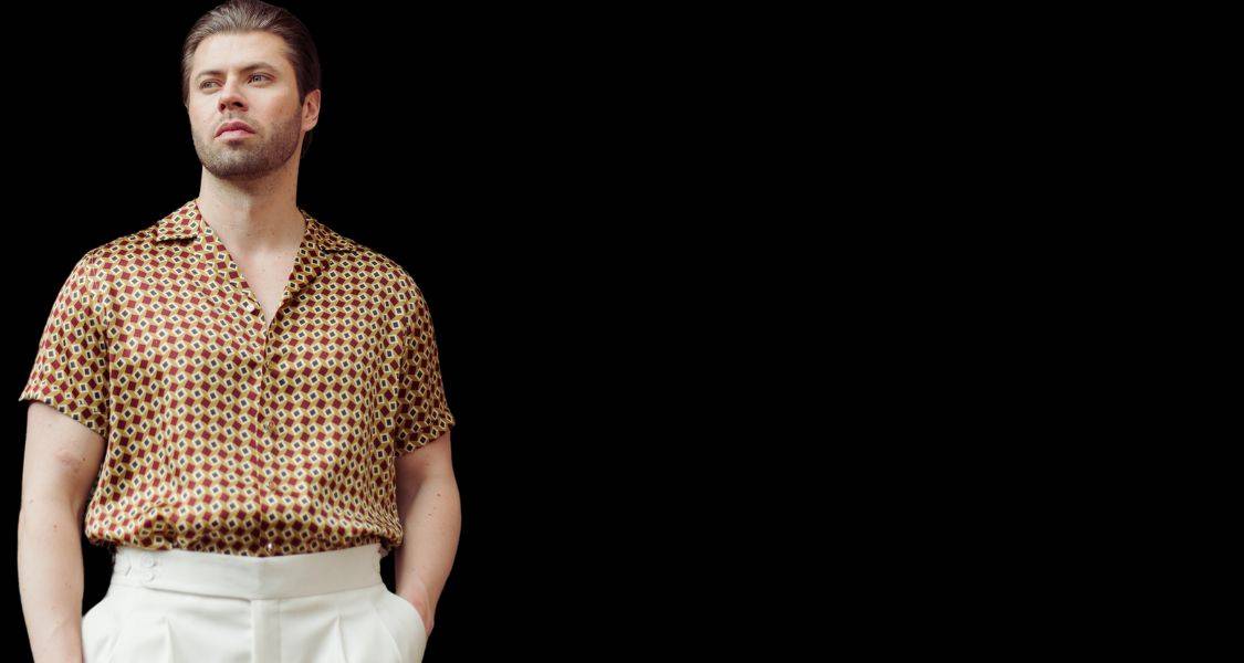 mens silk dress shirts hero banner image with title and model posing in a silk shirt
