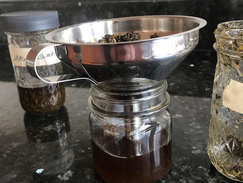 Dried herbs being made into a tincture 