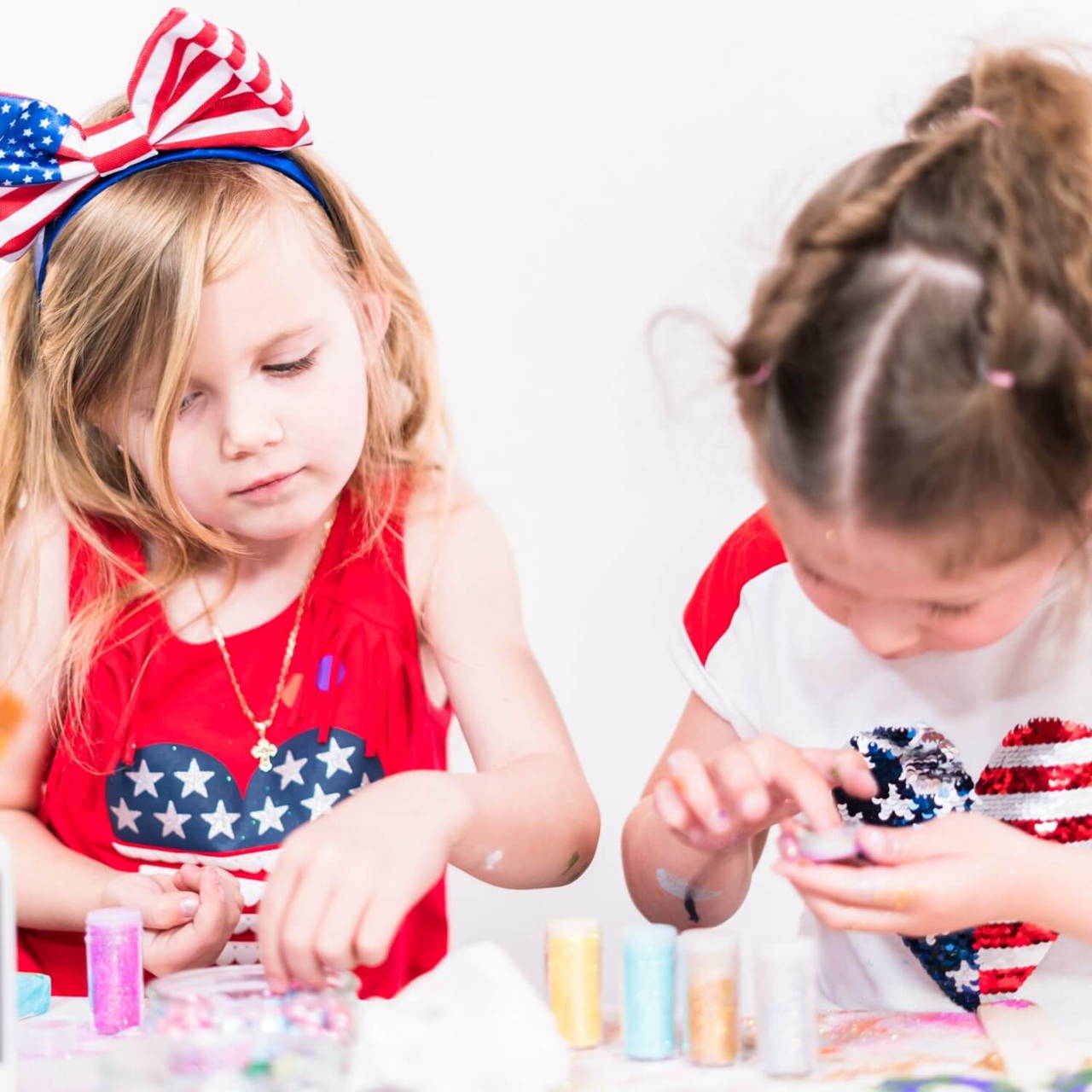 Girls doing crafts on a lawn