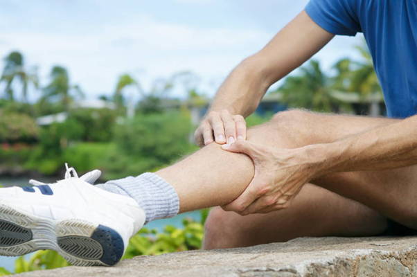 Man massaging sore calves