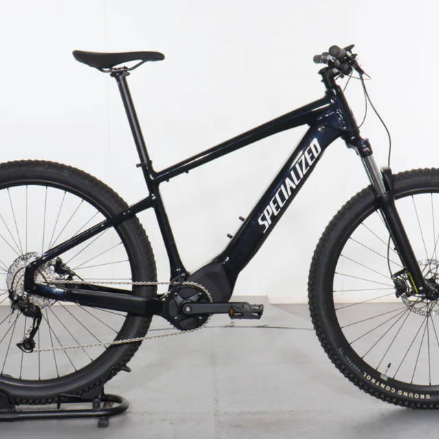 a black Specialized Turbo Tero 5.0 front suspension electric mountain bike