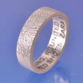 a fingerprint hand engraved onto a wedding band. a lovely memory ring 