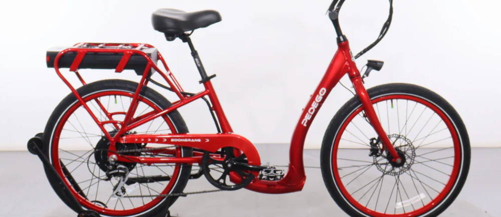 a red Pedego Boomerang step through electric bike
