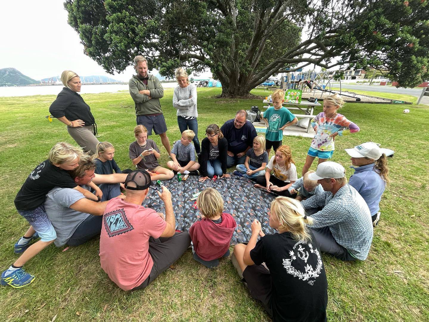 Large group uses the meadow mat for lunch, snacks, and card games. Shown in Urban Camo on an island near a marina.