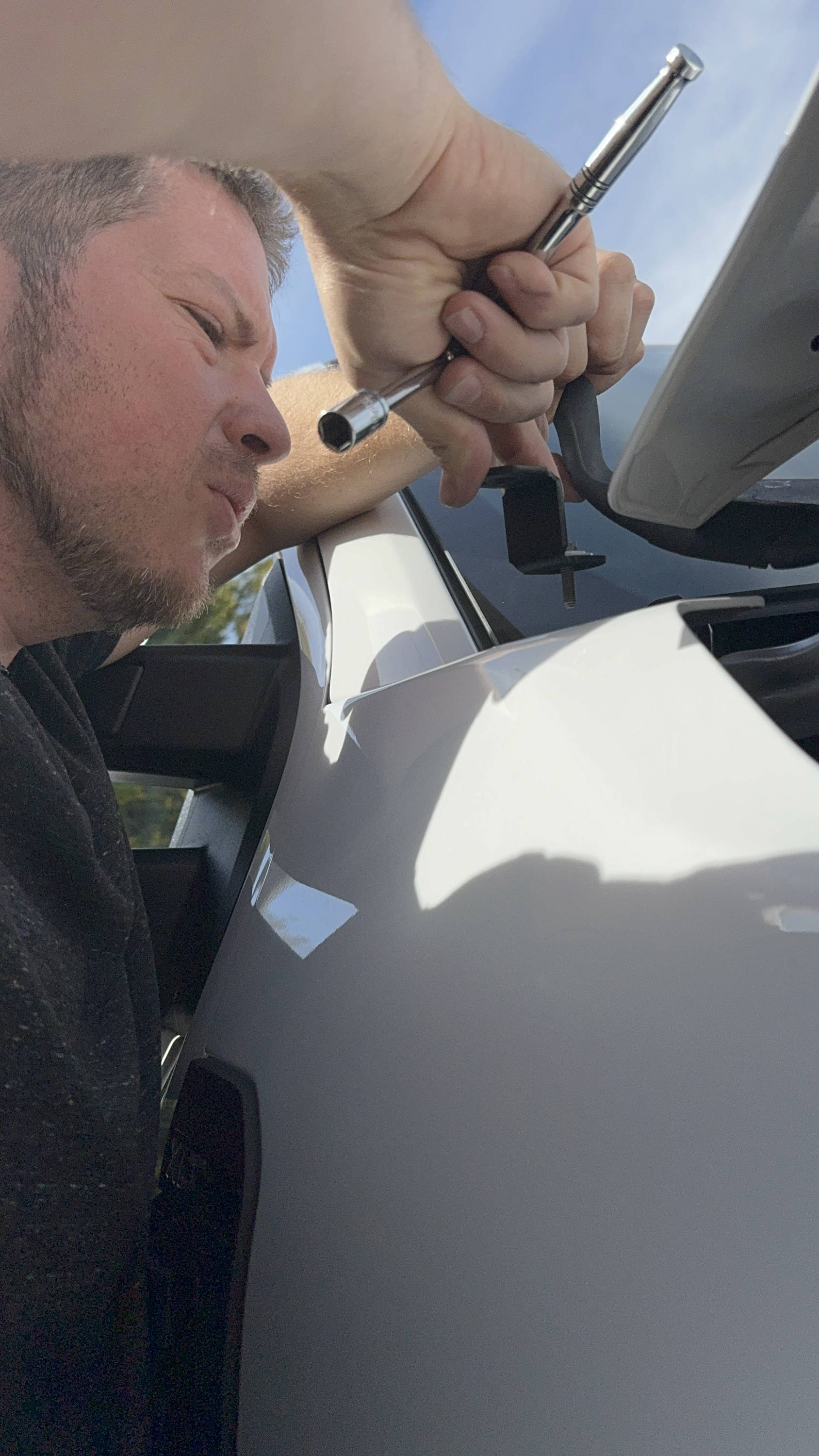 mike owner of m&R automotive installs ditch lights on white ford superduty
