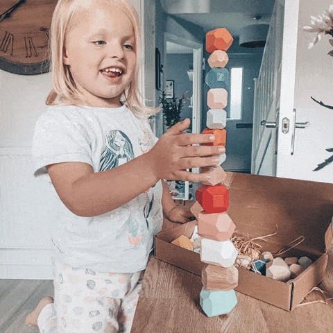 Animated gif showing children playing with the Montessori Wooden Stones. 
