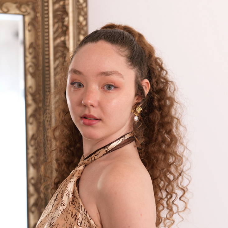 Davines model with blonde short curly hair with bangs