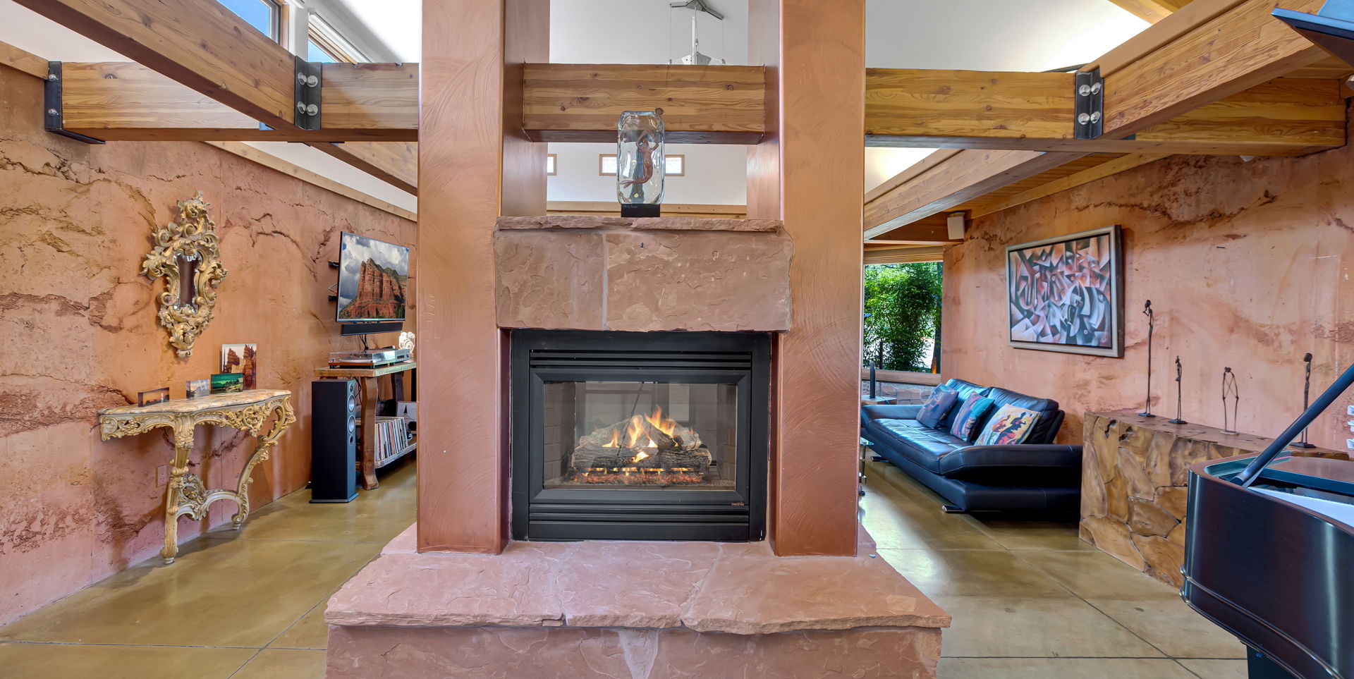 tiled living room with a fireplace and natural light