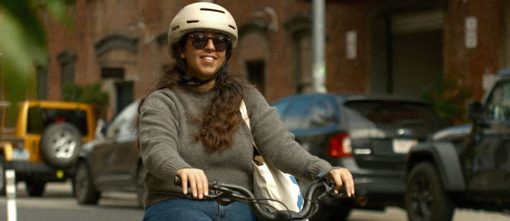 Woman riding electric bike with helmet