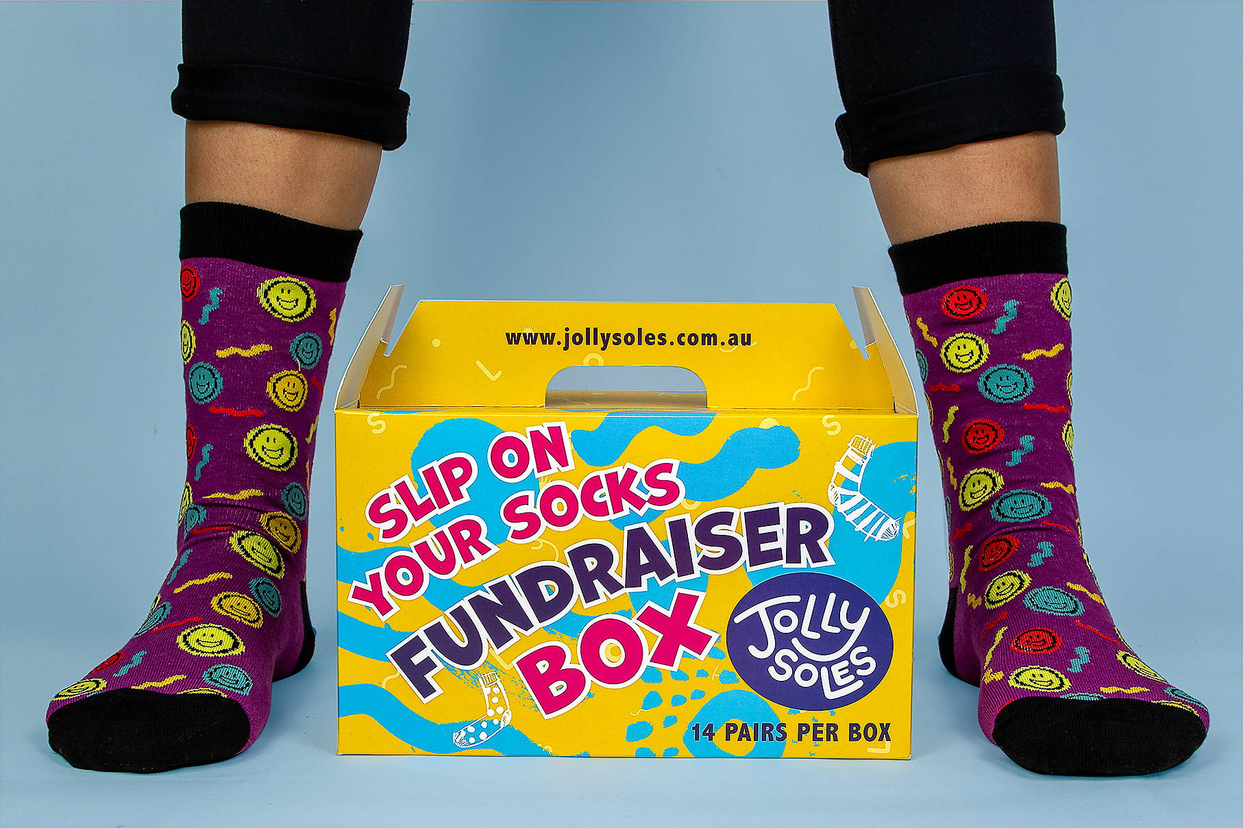 Jolly Soles Fundraiser Sock Box Yellow Box and Purple Smiley Face Socks