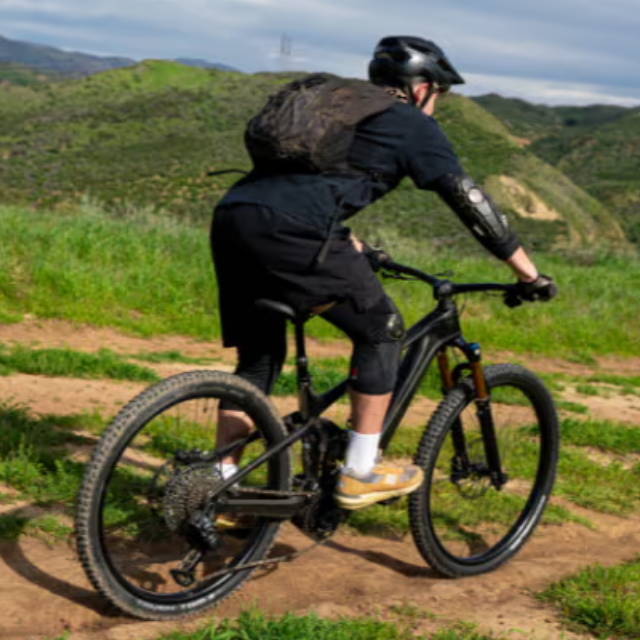 a man riding an electric mountain bike in the wilderness