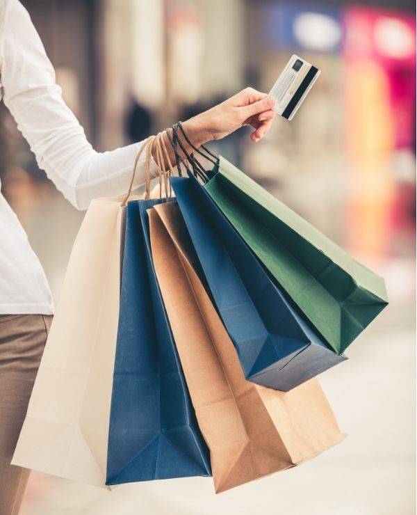Woman with shopping bags and credit card