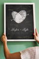 woman hanging black and white fingerprint heart wedding guest book alternative