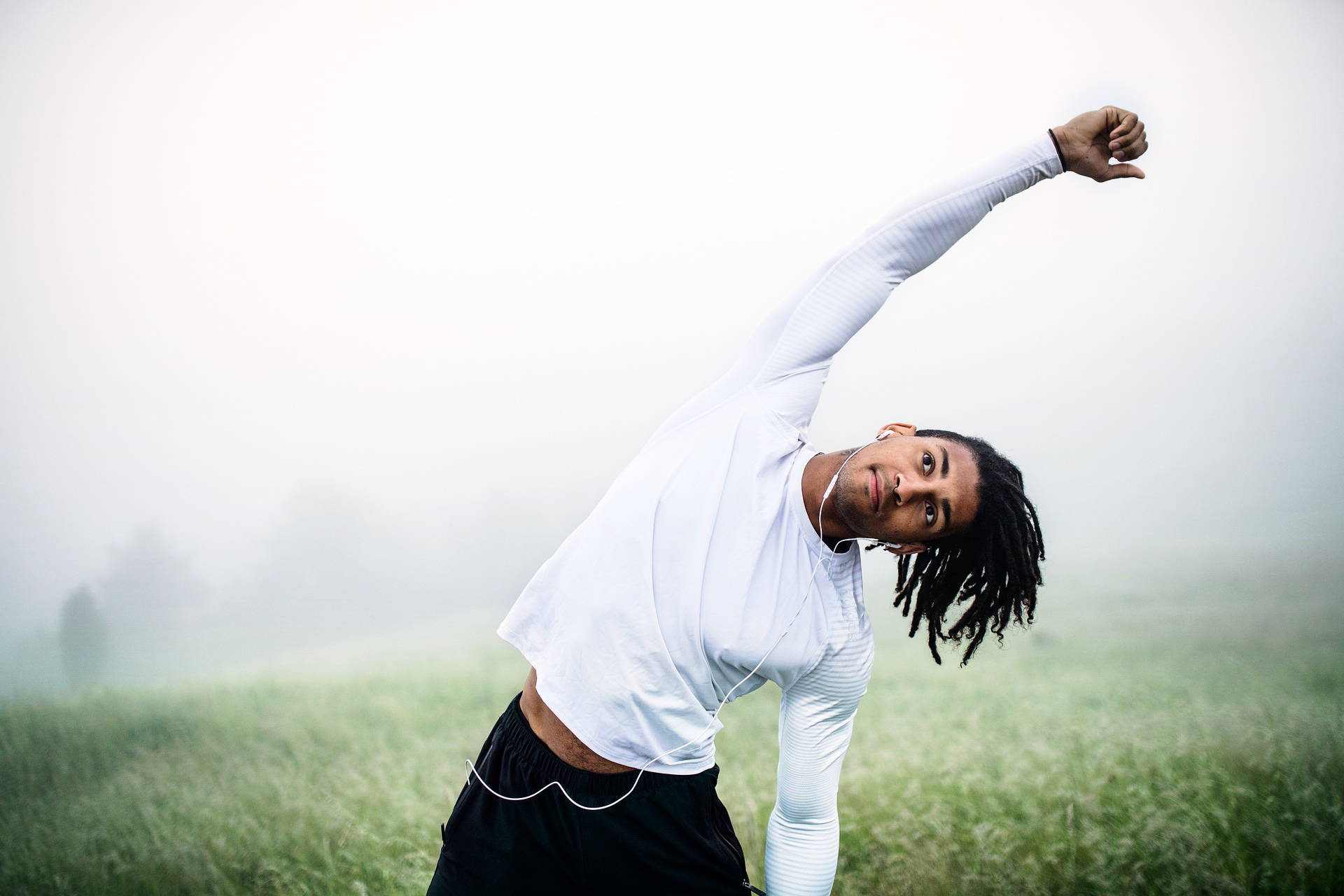 Young man stretching outside