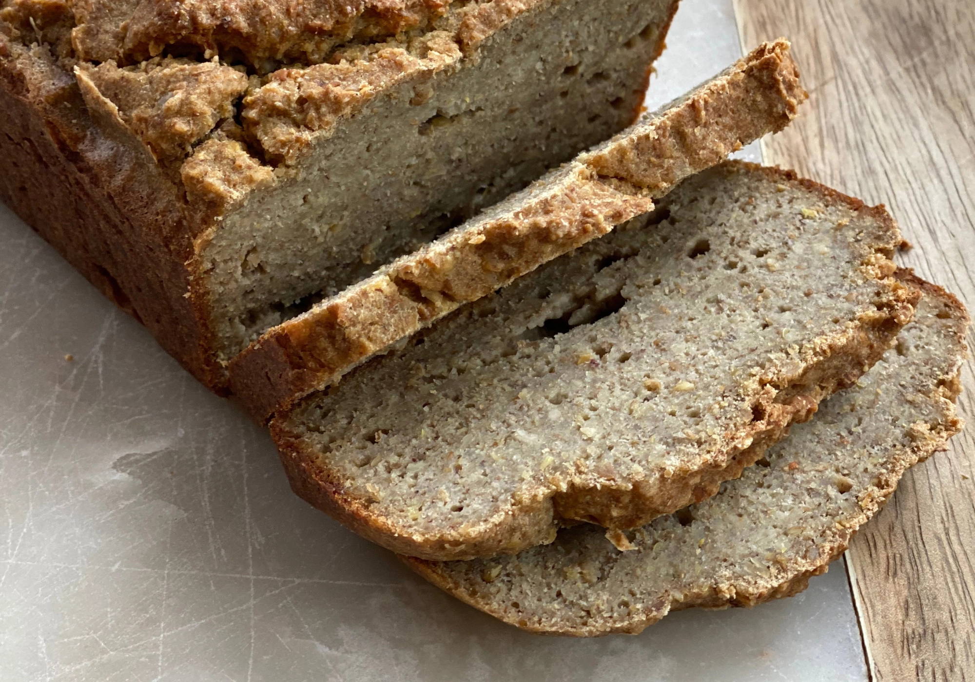Fresh loaf of PACHA sprouted buckwheat bread on a kitchen counter.