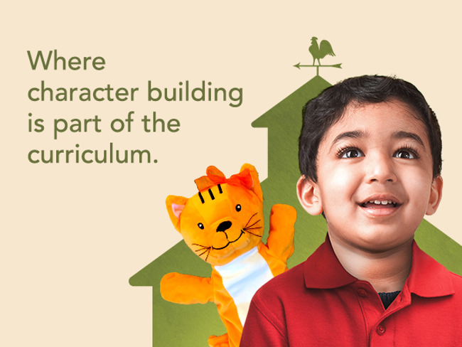 young boy smiling in front of a school house. text on the image says Where character building is part of the curriculum.​