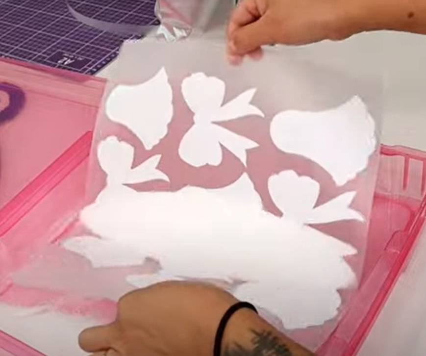 Hot melt powder being applied to DTF printed film before curing