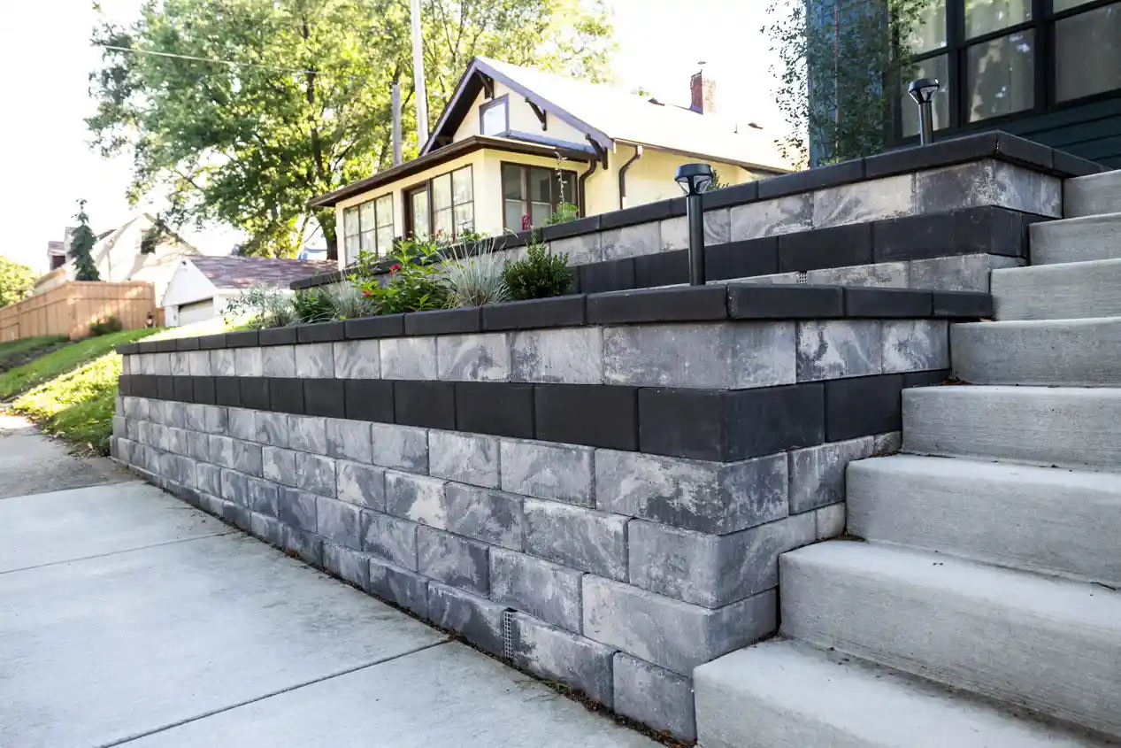 a Multilevel retaining wall system built with Tribute Smooth blocks with a staircase