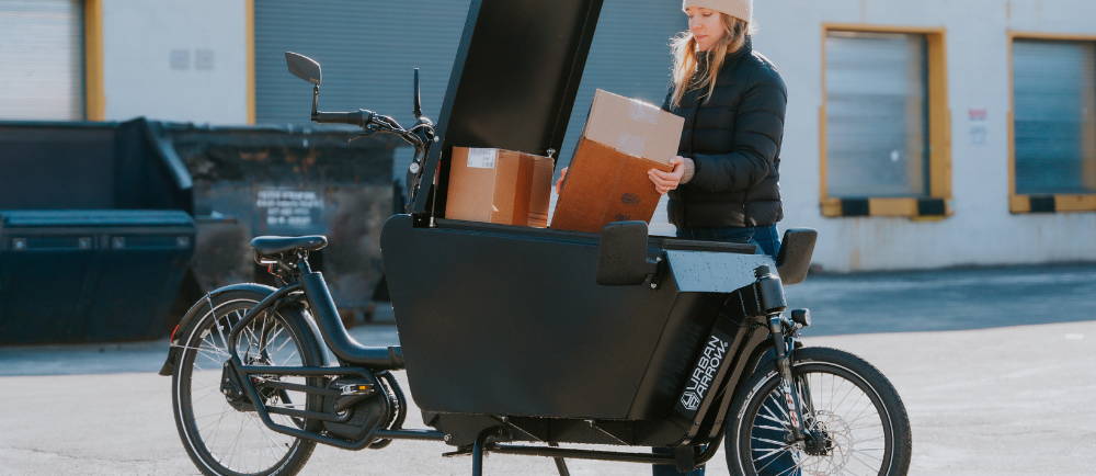 a woman loading up an Urban Arrow electric cargo bike