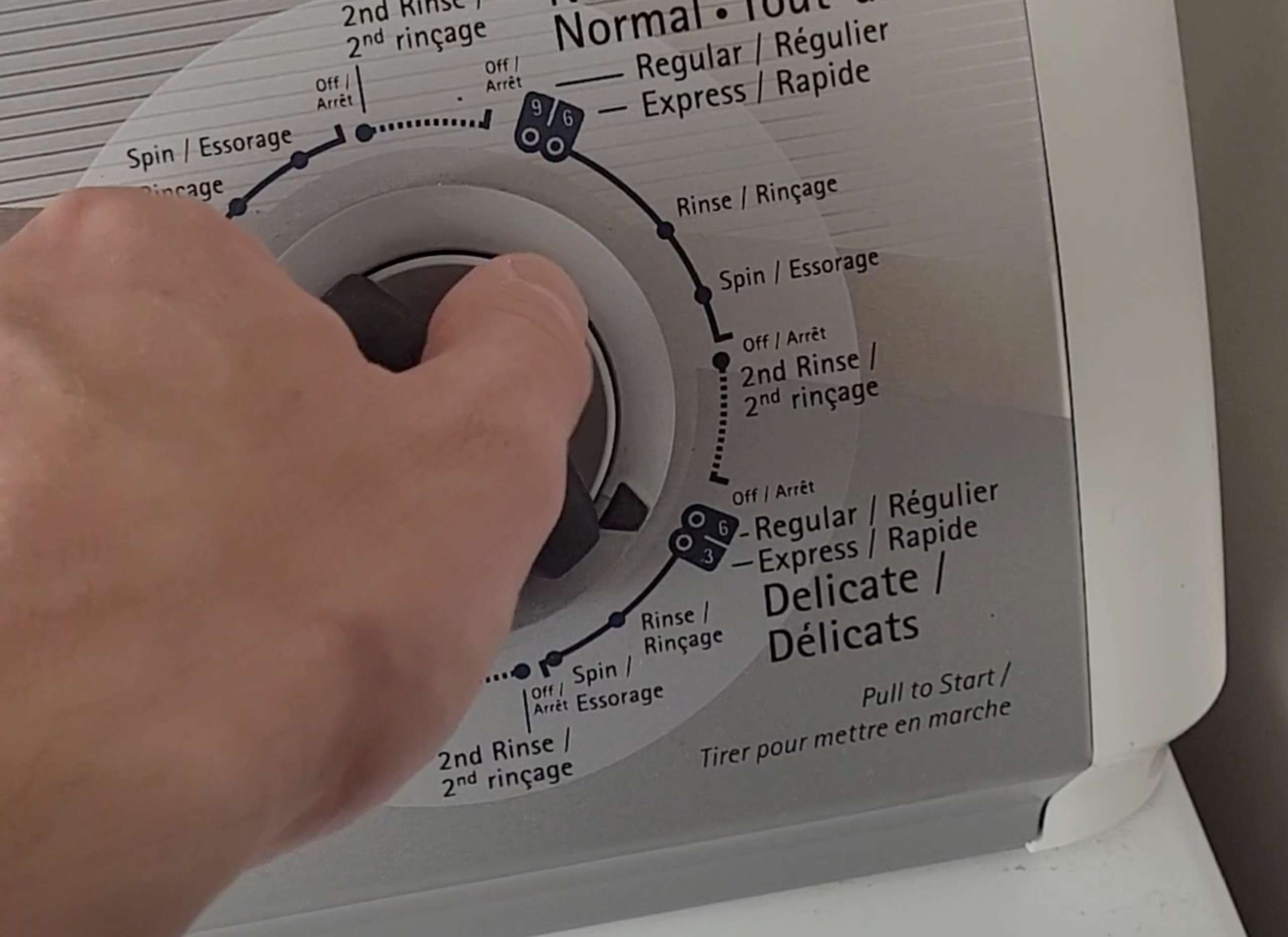photo of the start button on a washing machine