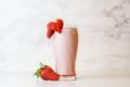healthy vegan strawberry collagen smoothie in a glass