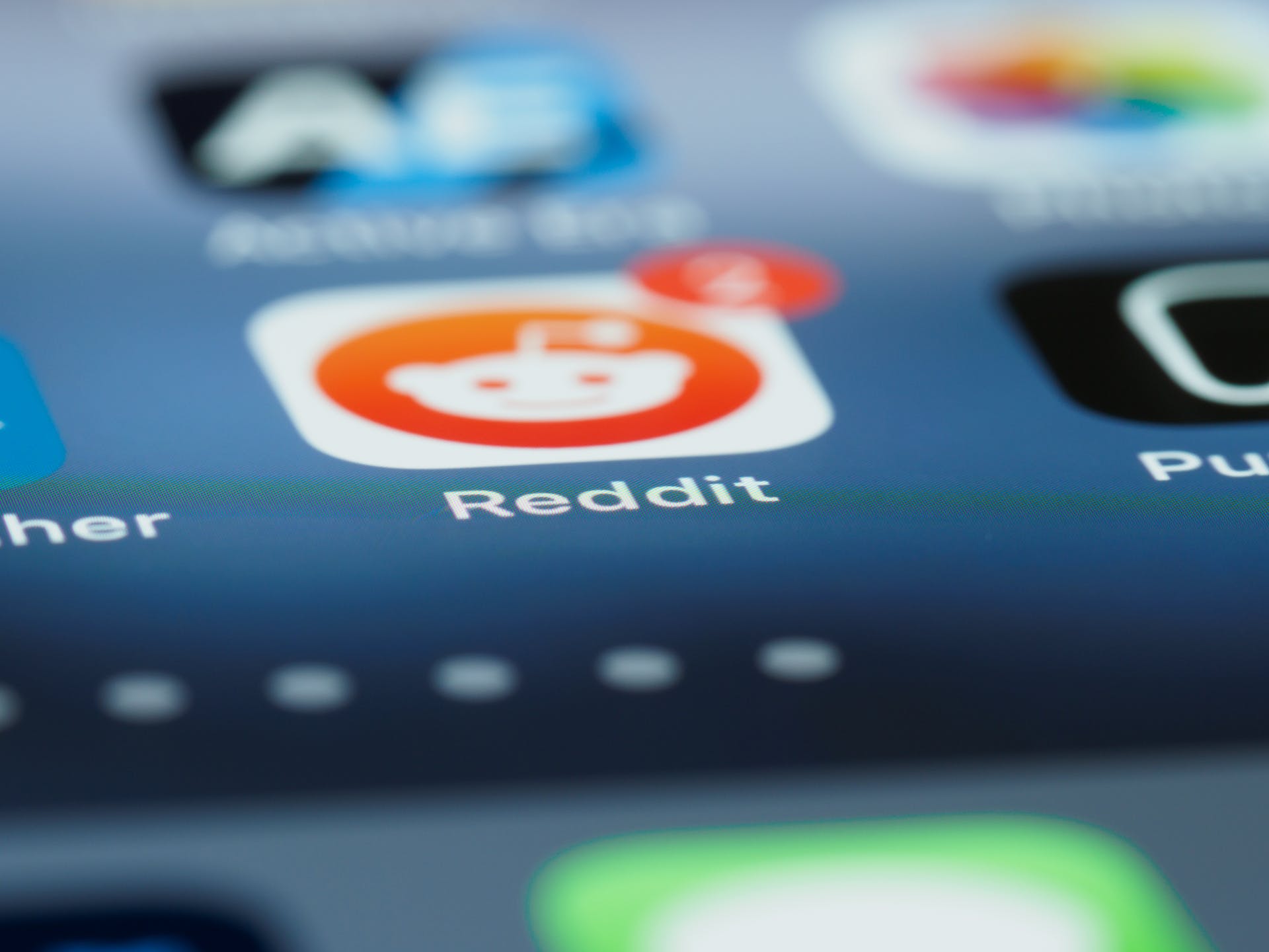 A close-up of the Reddit icon of a smartphone menu