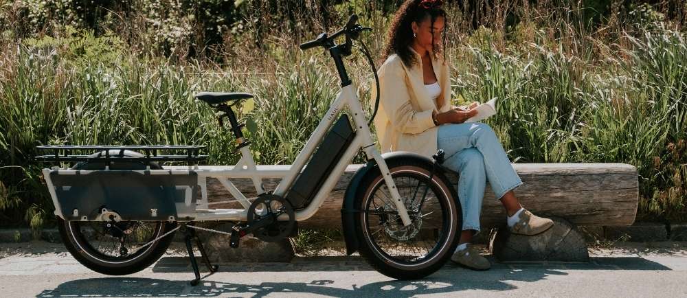 Female reading her book next to her Specialized Haul LT