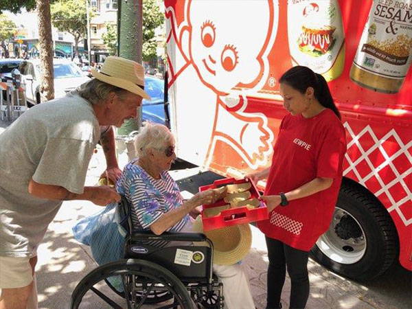 Woman in wheelchair sampling Kewpie