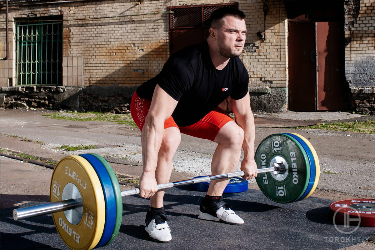 athlete deadlifting outdoors