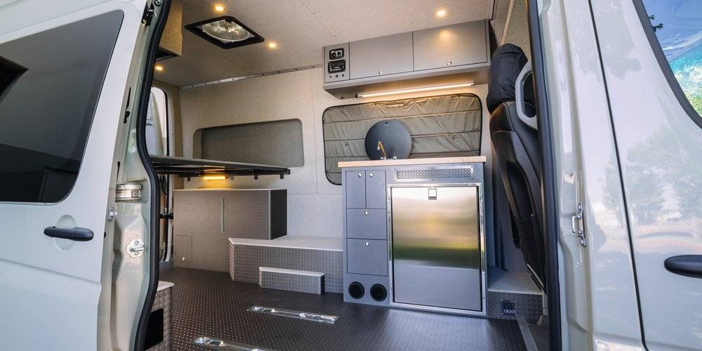 A conversion van interior is shown with Flarespace Flares installed which open up space
