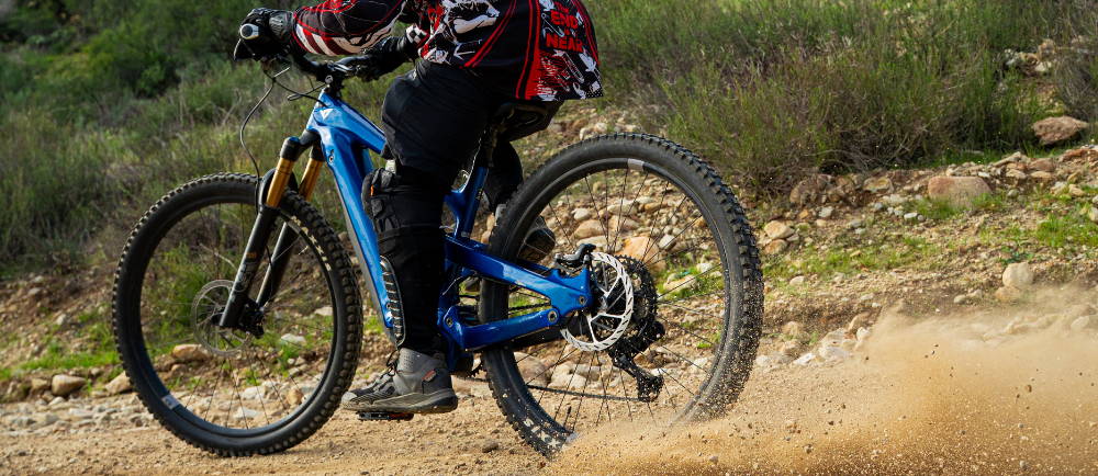 An E-MTB doing a skid on gravel