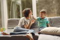 Mother and son sitting on a sofa and enjoying their time together. 