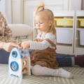 Little girl playing with the Montessori Learning Rocket toy.