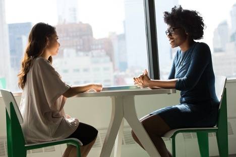 Two women talking business at a table
