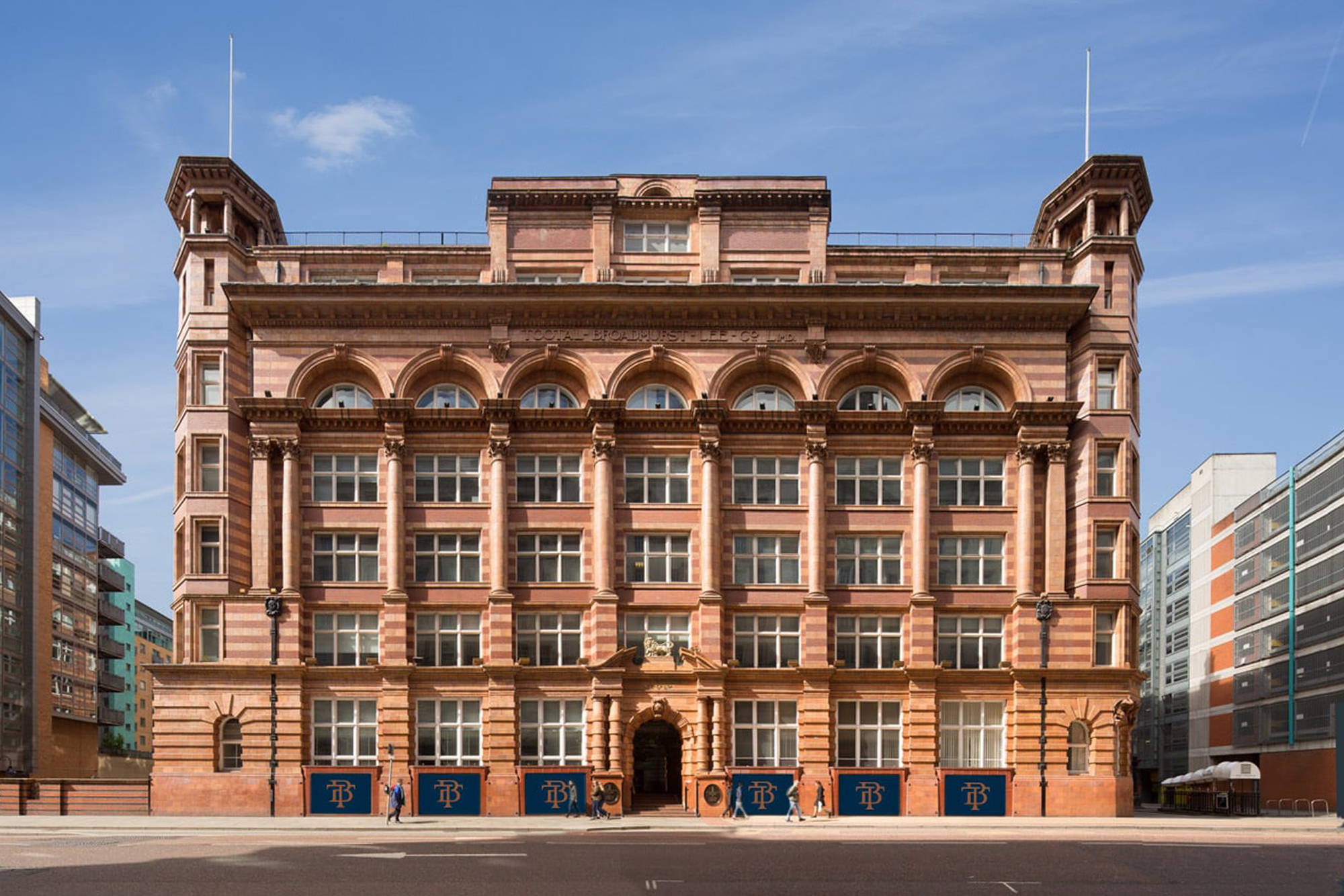 An image of the exterior of the Tootal buildings in Manchester on a sunny day.