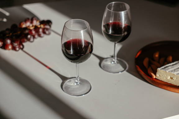 Two red wine glasses highlighting the importance a larger bowl and broader rim to increase oxidation.