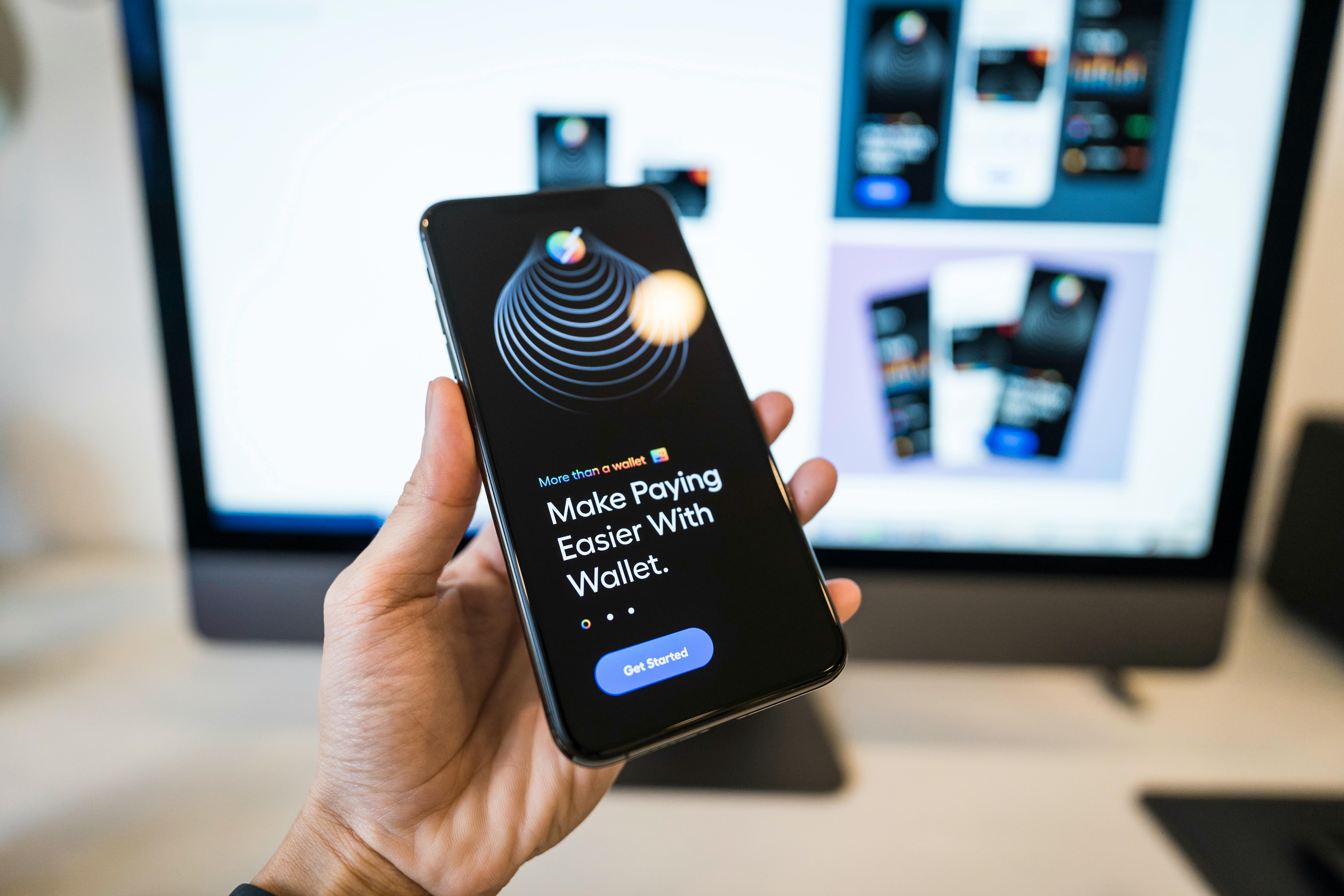A person holding a phone with a digital wallet application open