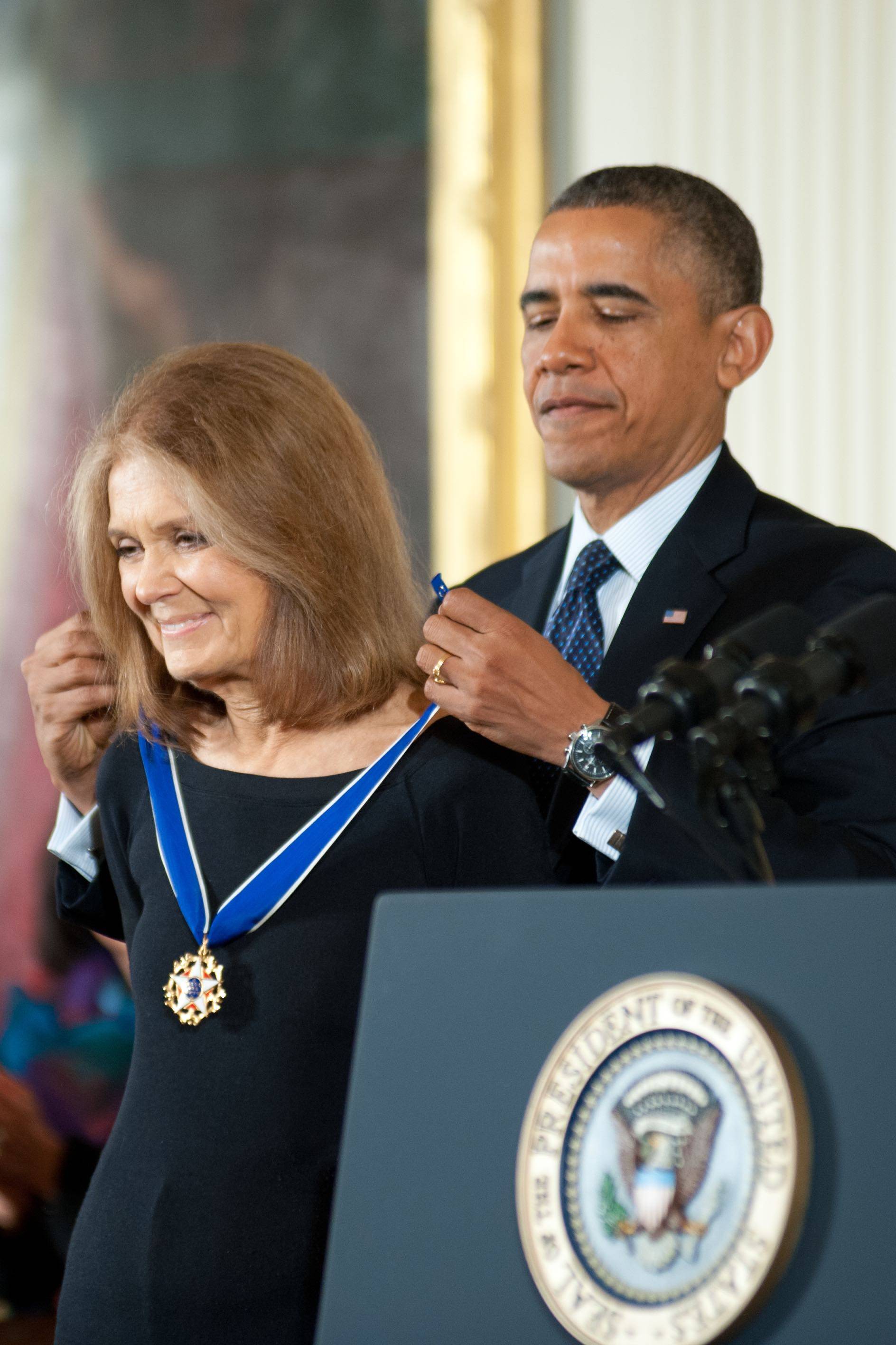 Gloria Steinem receiving medal from Barack Obama