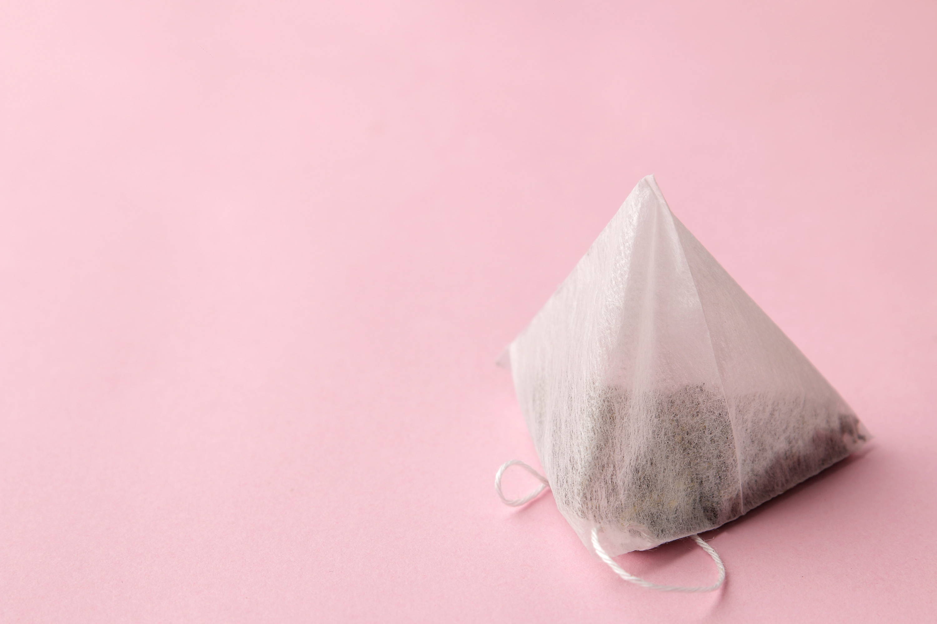 Tea bag on a plain background as a way to add flavour to plain water