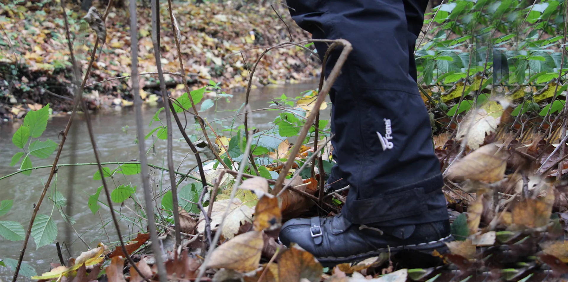 This man is showing the side-leg zippered trouser legs of the fishing pants