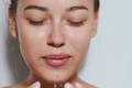 woman rinsing her face after washing with water