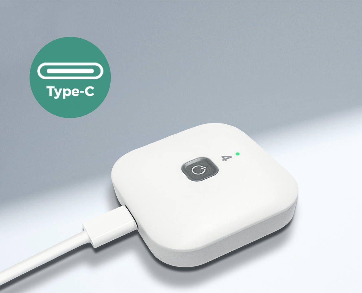 Close-up of the Wellue cable-free TENS therapy pod charging with a USB-C cable, showing the convenient Type-C charging design