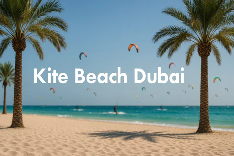 Kite Beach Dubai featuring palm trees and a sunny sky. Colorful kites fly above the turquoise water where kite surfers are active on the beach.