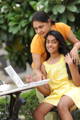 Loving mother and daughter with laptop in outdoors