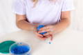 Girl playing with a blue make dough.