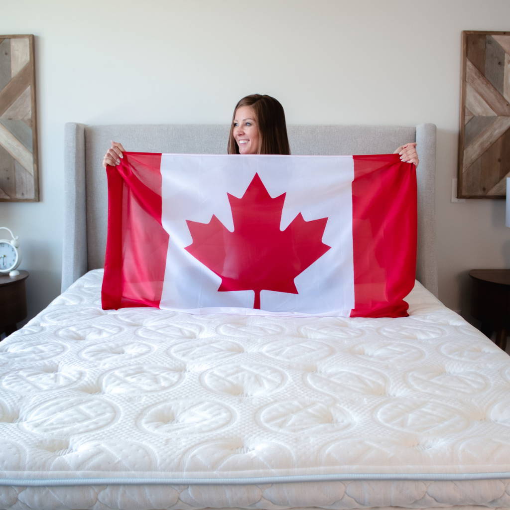 Couple sitting up in bed on a haven sleep co adjustable bed frame
