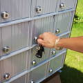 hand-opening-mailbox-with-key