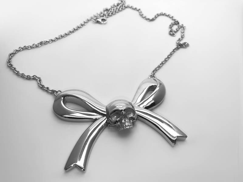 silver skull and cross pendant on ribbon